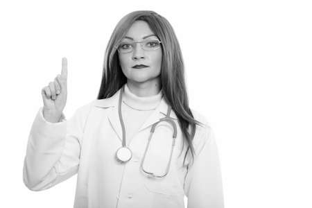 Studio shot of woman doctor pointing finger upの写真素材