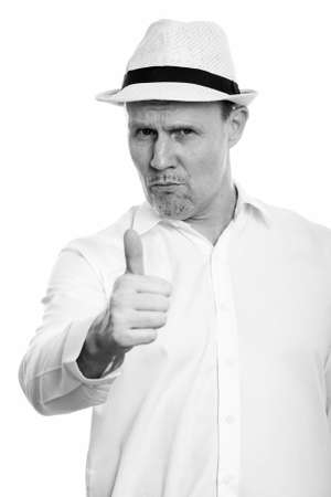 Studio shot of mature man giving thumb upの写真素材