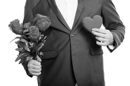 Studio shot of businessman holding roses and heart ready for Valentines dayの写真素材