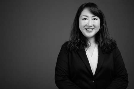 Portrait of happy mature beautiful Asian businesswomanの写真素材