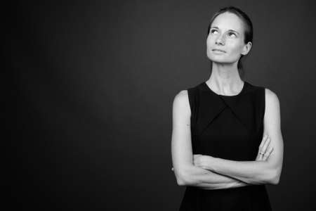 Studio shot of beautiful woman against gray backgroundの写真素材