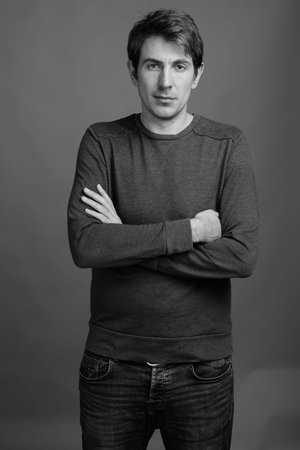 Portrait of handsome man against gray background