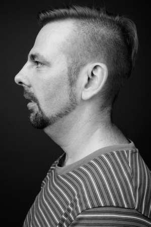Blond bearded man with goatee against gray backgroundの写真素材