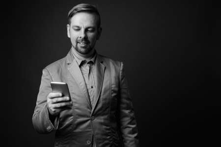 Blond bearded businessman with goatee against gray backgroundの写真素材