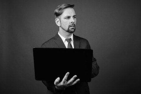 Blond bearded businessman with goatee against gray backgroundの写真素材