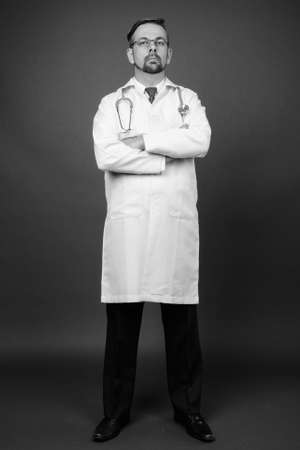 Blond bearded man doctor with goatee against gray backgroundの写真素材