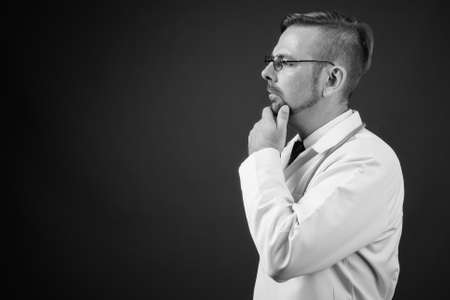 Blond bearded man doctor with goatee against gray backgroundの写真素材