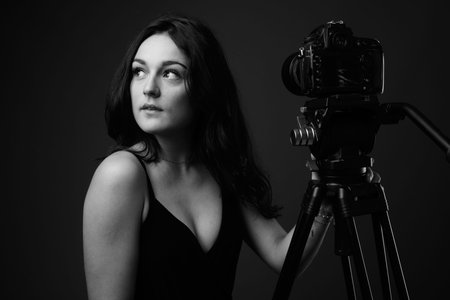 Studio shot of young beautiful woman against gray background