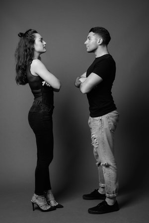 Young couple together and in love against gray background