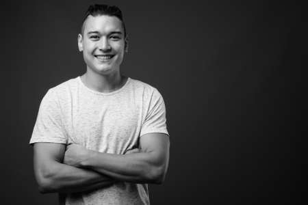 Young handsome multi ethnic man against gray backgroundの写真素材
