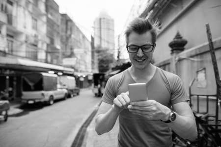 Young handsome tourist man exploring around the city streetsの写真素材