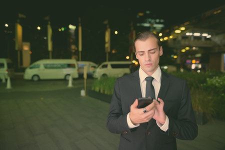 Young businessman exploring the city of Bangkok, Thailand at night