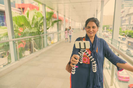 Mature beautiful Indian woman exploring the city of Bangkok, Thailandの写真素材