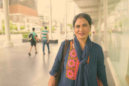 Mature beautiful Indian woman exploring the city of Bangkok, Thailand