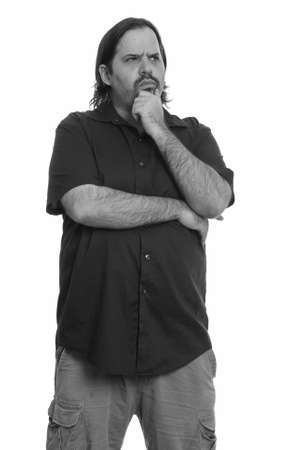 Profile view of overweight bearded man thinking and looking upの写真素材