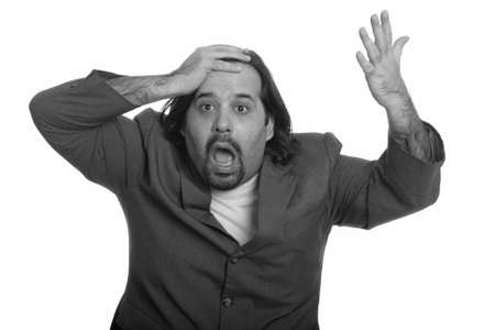 Fat Caucasian businessman with hand on head looking shockedの写真素材