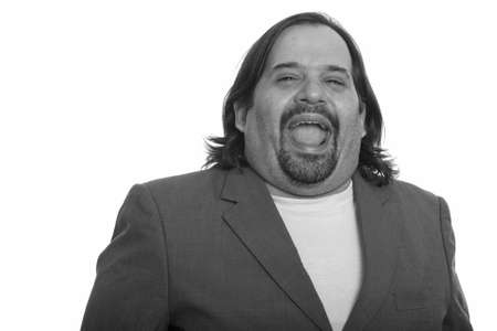 Happy fat Caucasian businessman smiling and laughingの写真素材