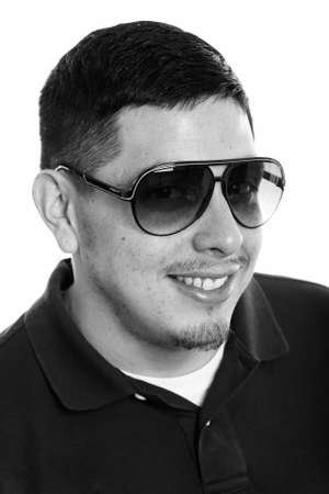 Face of young happy Hispanic man smiling while wearing sunglassesの写真素材