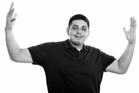 Studio shot of young Hispanic man with open arms
