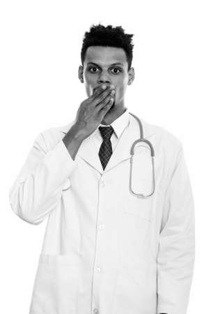 Studio shot of young African man doctor looking shockedの写真素材