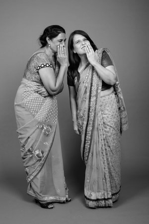 Two mature Indian women wearing Sari Indian traditional clothes togetherの写真素材