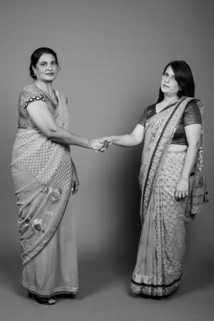 Two mature Indian women wearing Sari Indian traditional clothes togetherの写真素材