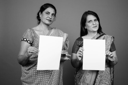 Two mature Indian women wearing Sari Indian traditional clothes togetherの写真素材