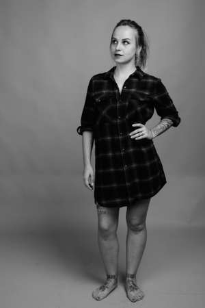 Young beautiful woman with blond hair against gray backgroundの写真素材