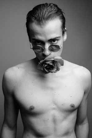 Young handsome man shirtless against gray background