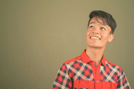 Young handsome Indian man against colored backgroundの写真素材