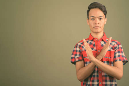 Young handsome Indian man against colored backgroundの写真素材