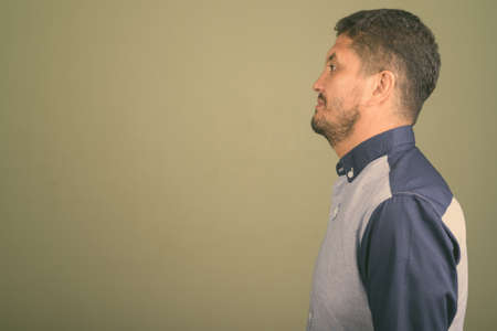 Portrait of bearded Persian businessman against colored backgroundの写真素材