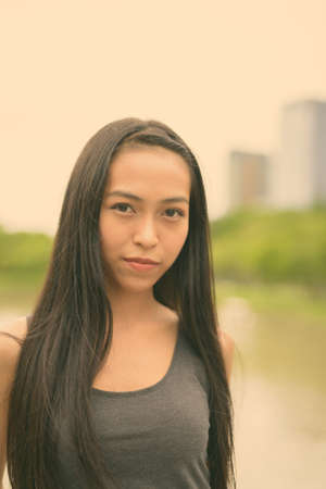 Young beautiful Asian woman relaxing at the parkの写真素材