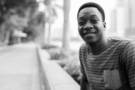 Young handsome African man relaxing at the parkの写真素材