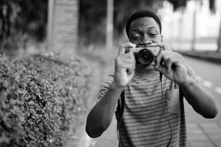 Young handsome African man relaxing at the parkの写真素材