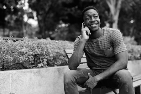 Young handsome African man relaxing at the park