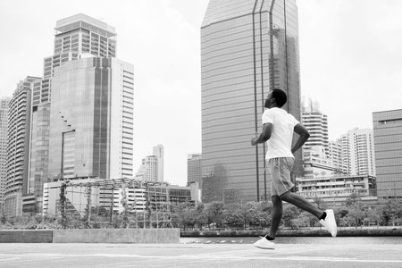 Young handsome African man exercising at the park