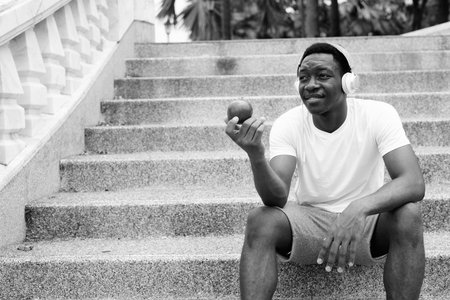Young handsome African man exercising at the park