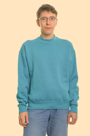 Studio shot of man standing while wearing eyeglassesの写真素材