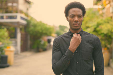 Young handsome African businessman in the streets outdoorsの写真素材