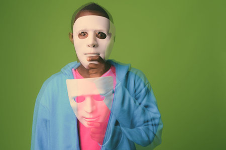 Studio shot of young African man against green background
