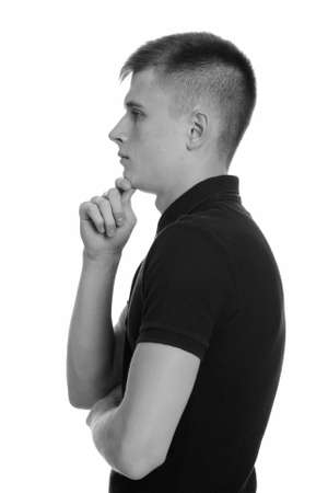 Profile view of young Caucasian man thinkingの写真素材