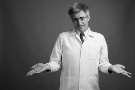 Man doctor with blond hair against gray backgroundの写真素材