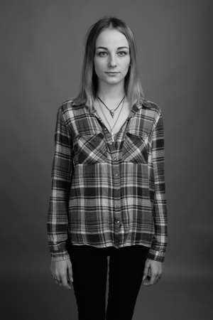 Young beautiful rebellious woman with dyed hair against gray backgroundの写真素材