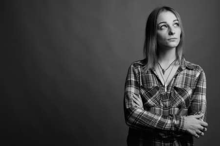 Young beautiful rebellious woman with dyed hair against gray backgroundの写真素材