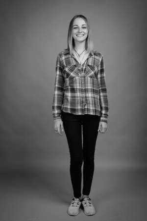 Young beautiful rebellious woman with dyed hair against gray backgroundの写真素材