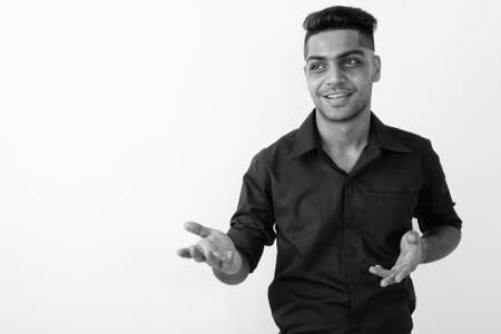 Portrait of young Indian businessman against white backgroundの写真素材