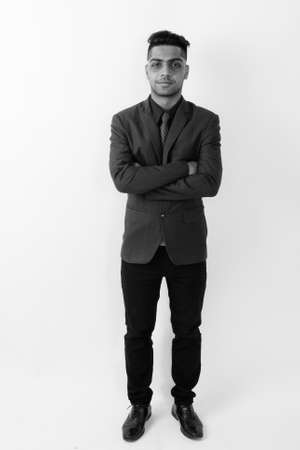 Young Indian businessman wearing suit against white backgroundの写真素材