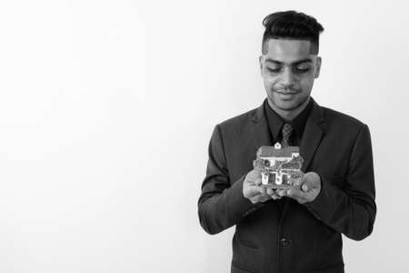 Young Indian businessman wearing suit against white backgroundの写真素材