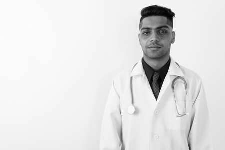 Young Indian man doctor against white backgroundの写真素材